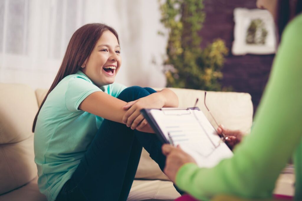 Girl teenager is happy after a successful therapy session by psychologists